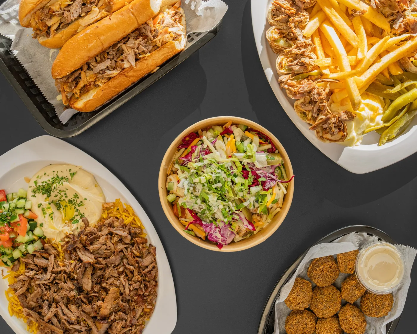 Top Shawarma spread with shawarma, bowls, plates, and falafel